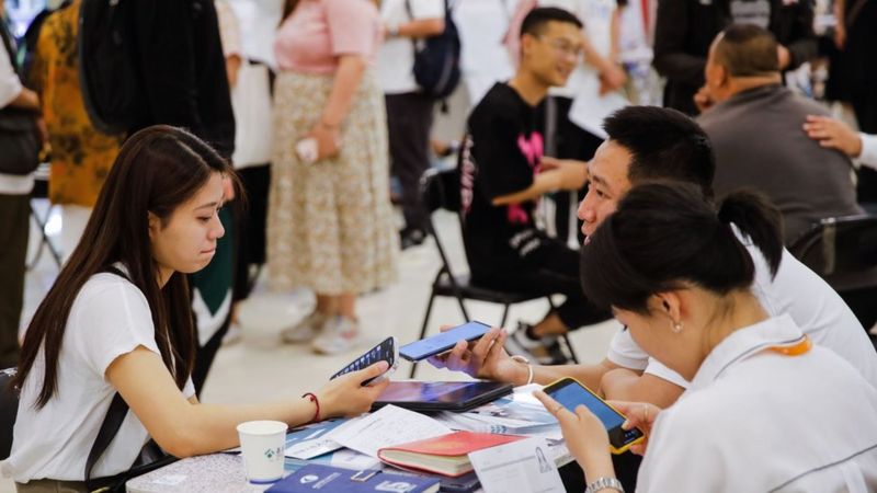 Job seekers and recruiters at a job fair in Beijing